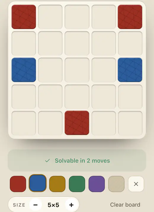 The builder: red and blue pieces placed on a five-by-five board, with the solver reporting 'Solvable in 2 moves' above a palette of colours.